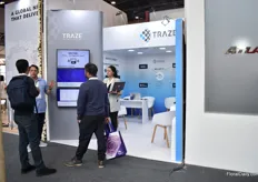 Traze team talking with visitors.